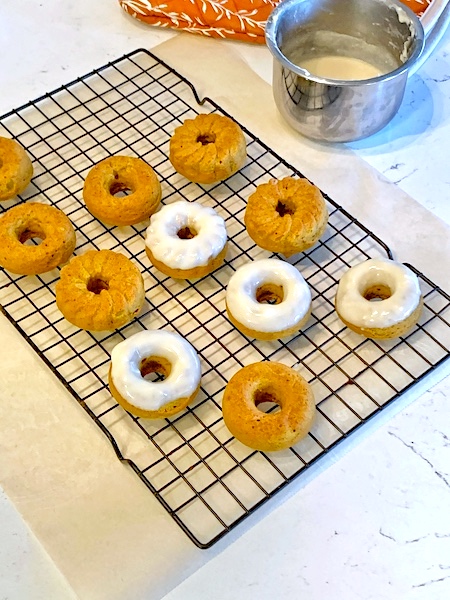 Maple Frosted Chai Pumpkin Donuts mid-frosting