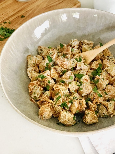 roasted potato salad with caramelized shallots close up